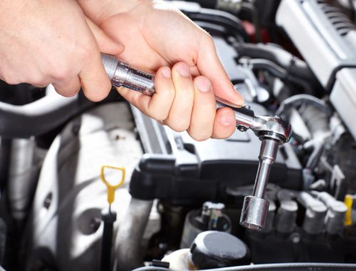 Hand with wrench. Mechanic. Auto repair shop.