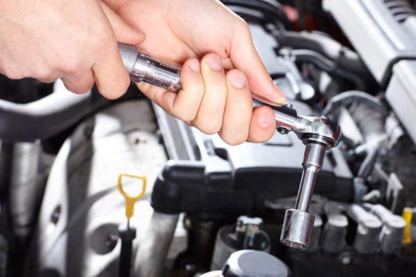 Hand with wrench. Mechanic. Auto repair shop.